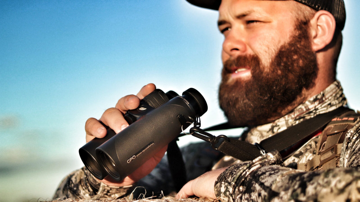 A Man Holding German Precision Optics Passion ED 8×42mm Binoculars Outdoors