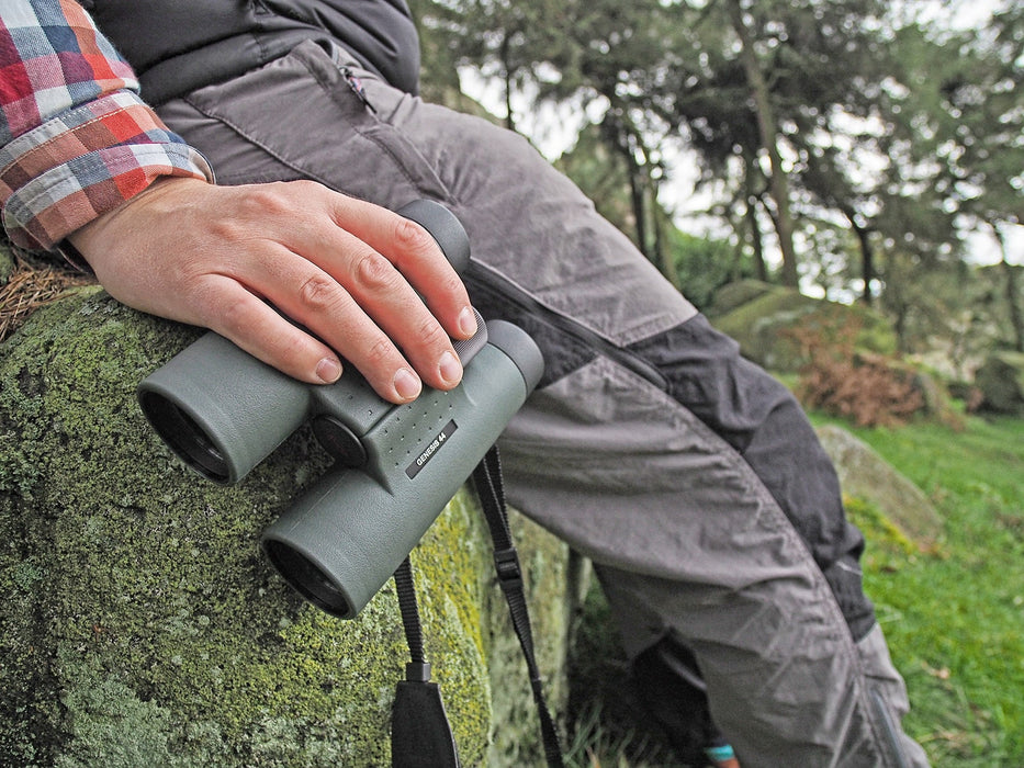 A Man Holding Kowa Genesis 44 10.5x44mm Prominar XD Binocular Outdoors