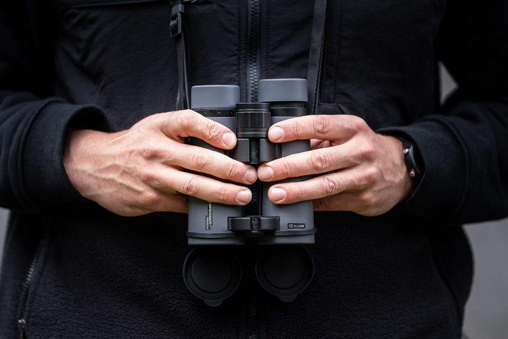 A Man Holding the Bresser Pirsch ED 8x42mm Binocular