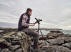 A Man Sitting on a rock with Kowa TSN-553 15-45x55mm Angled Spotting Scope Outdoors