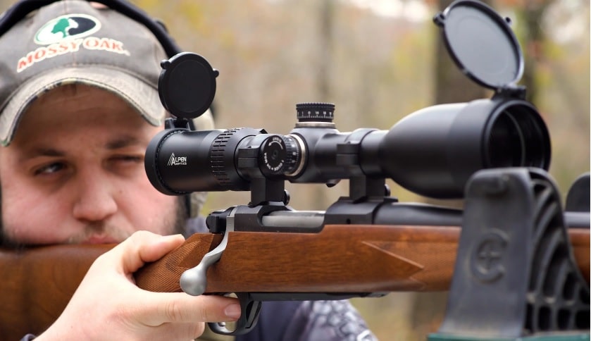 A Man Using Alpen Apex 2.5-15x50mm Riflescope Outdoors