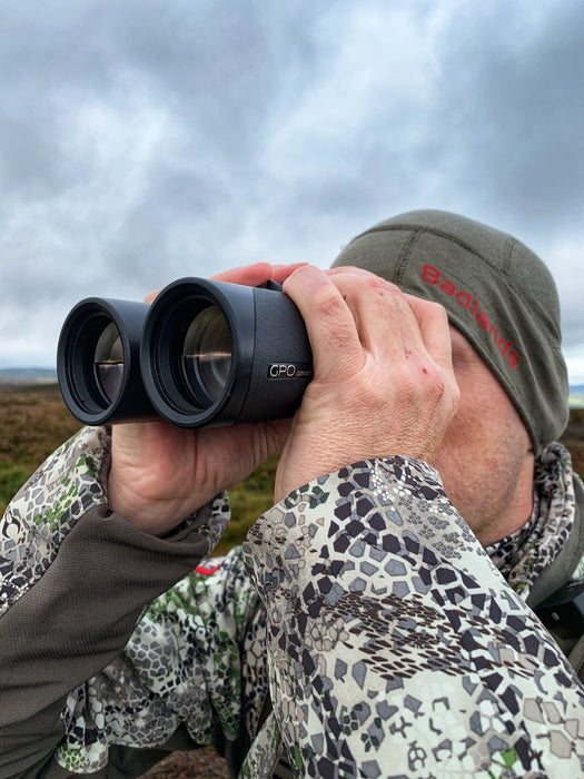 A Man Using German Precision Optics GPO Passion HD 10x50mm Binoculars Outdoors