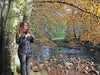 A Woman Standing beside Tree with Kowa Genesis 33 10x33mm Prominar XD Binocular