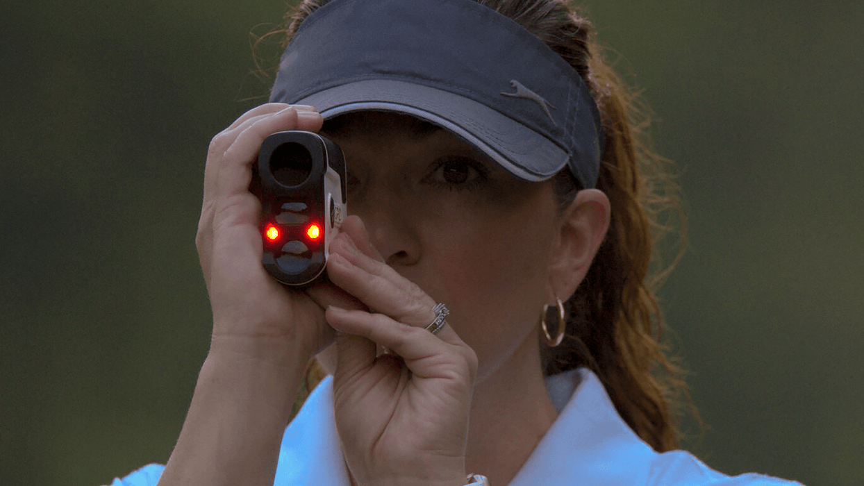 A Woman Using German Precision Optics GPO Flagmaster 1800 6x20mm Golf Laser Rangefinder