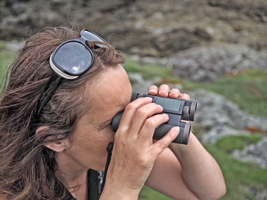 A Woman Using Kowa Genesis 22 8x22mm Prominar XD Binocular Outdoor