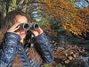 A Woman Using Kowa Genesis 33 10x33mm Prominar XD Binocular Outdoors