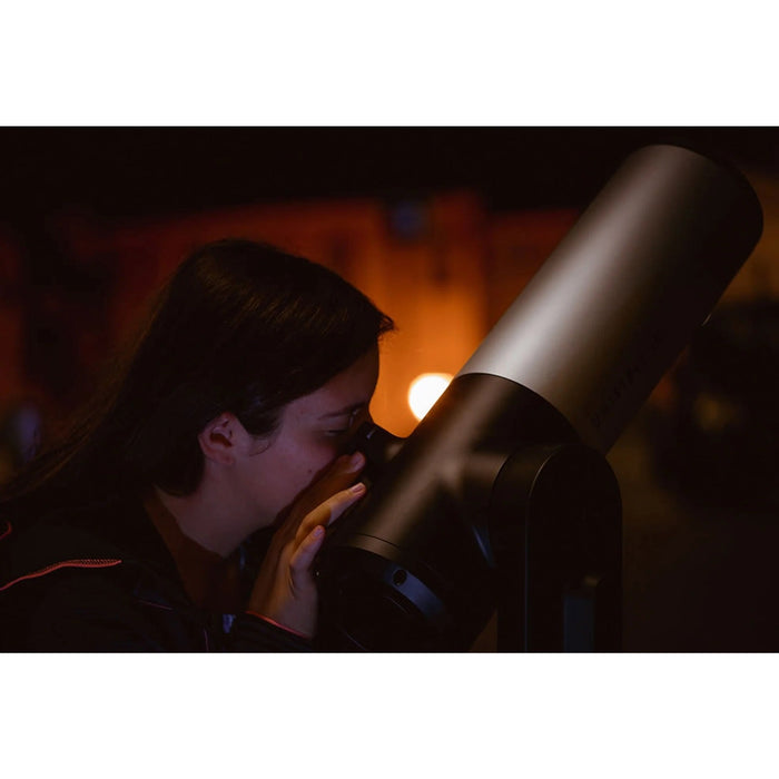 A Woman Using the Unistellar eVscope 2 Digital Telescope and Backpack