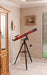 Carson Red Planet 50-111x90mm Refractor Telescope with Digiscoping Adapter Standing at the Corner Indoors