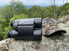 German Precision Optics GPO Rangeguide 8x50mm Binoculars and Hat Lying on Rock
